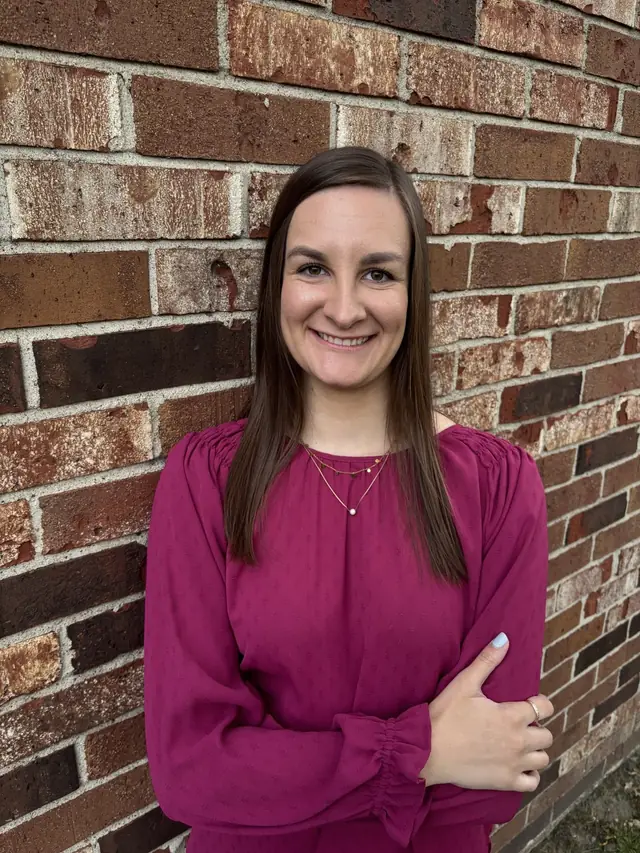 Morgan Walcott, DPT, in front of a brick wall