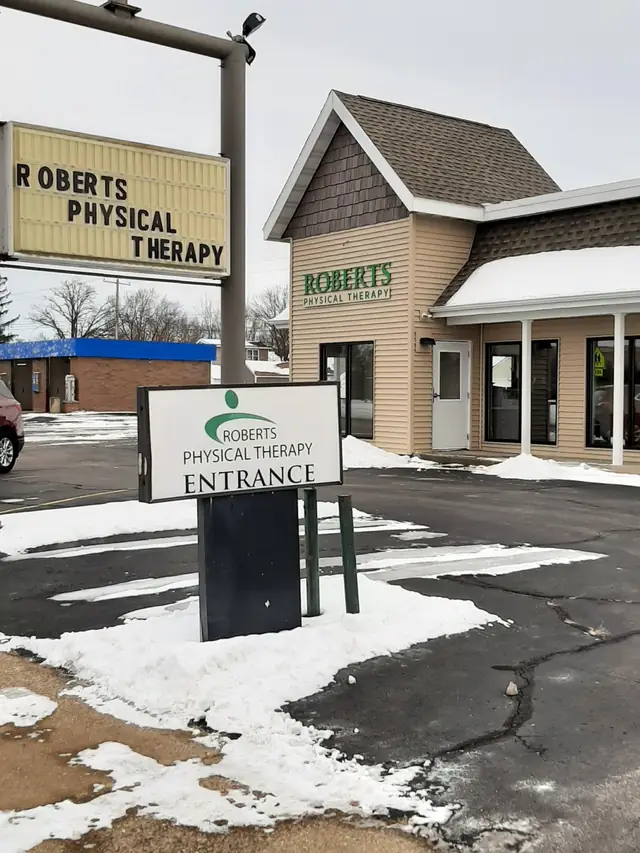 The Wisconsin Rapids clinic in winter, with the Roberts Physical Therapy sign and an ENTRANCE sign by the gable