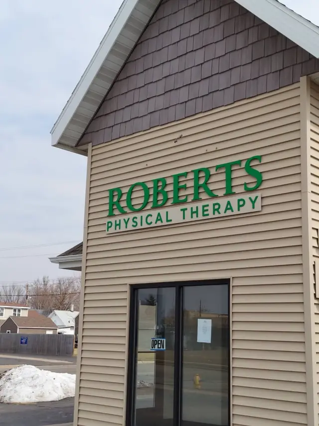 Green ROBERTS PHYSICAL THERAPY lettering on the clinic gable above the front door